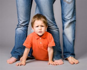 child between parents' legs