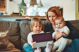 mother with her children watching on ipad