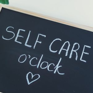Chalkboard with self care o'clock on it